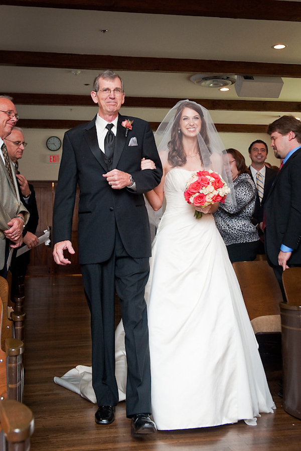 The Beautiful Bride And Her Father Walking Down The Aisle During The Ceremony Bride Is Wearing